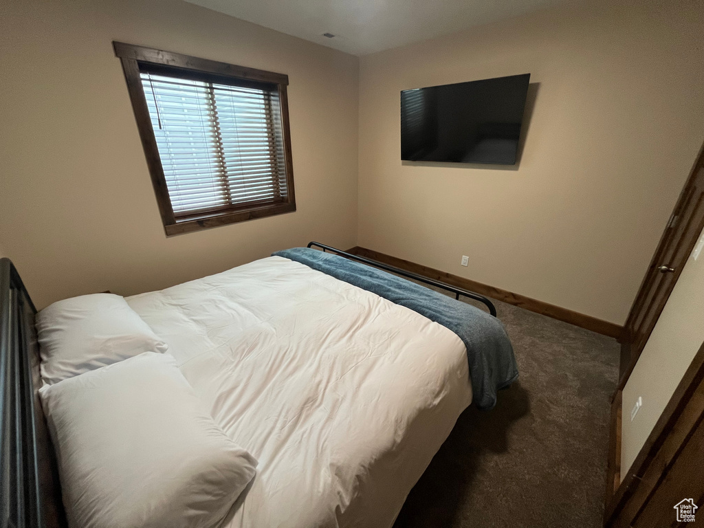 Carpeted bedroom with baseboards
