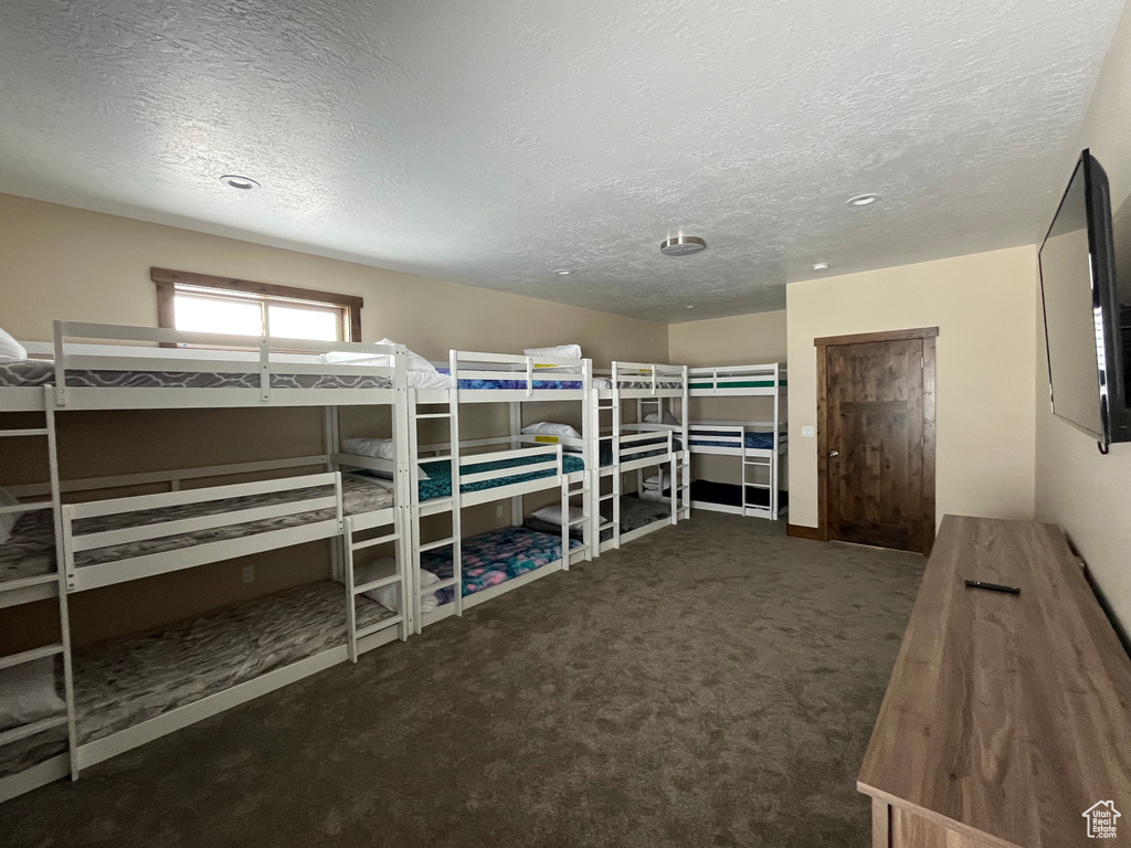 Bedroom featuring a textured ceiling and carpet flooring