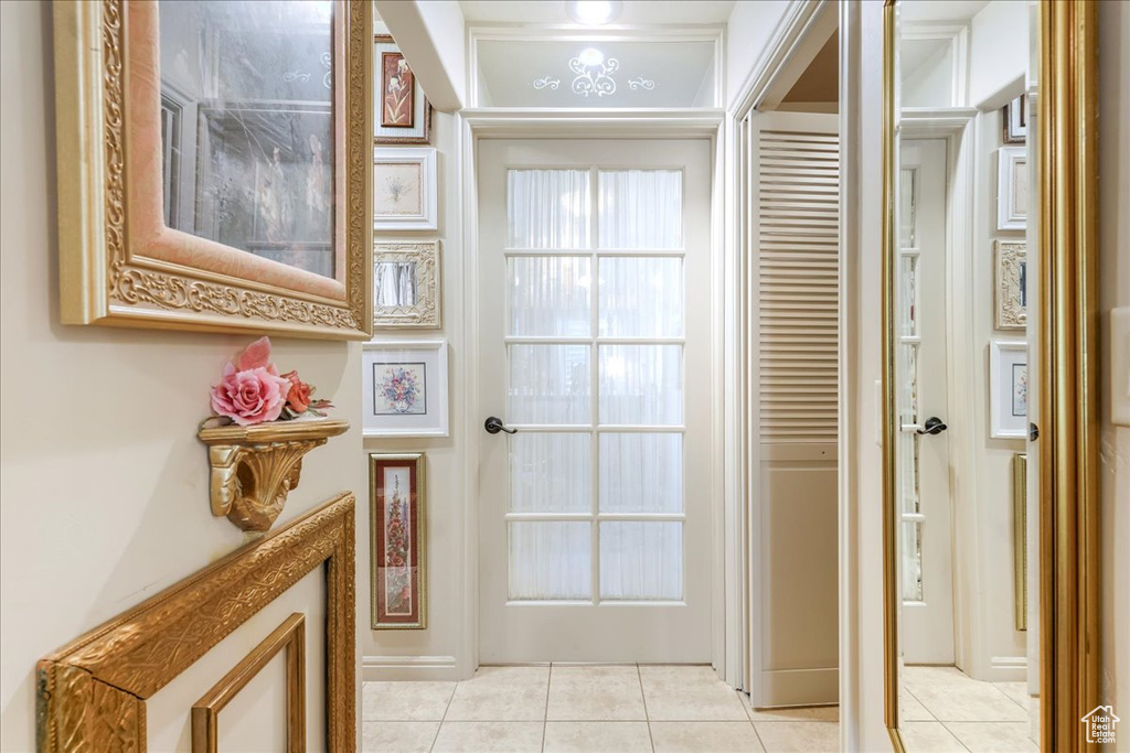 Hallway featuring light tile patterned flooring