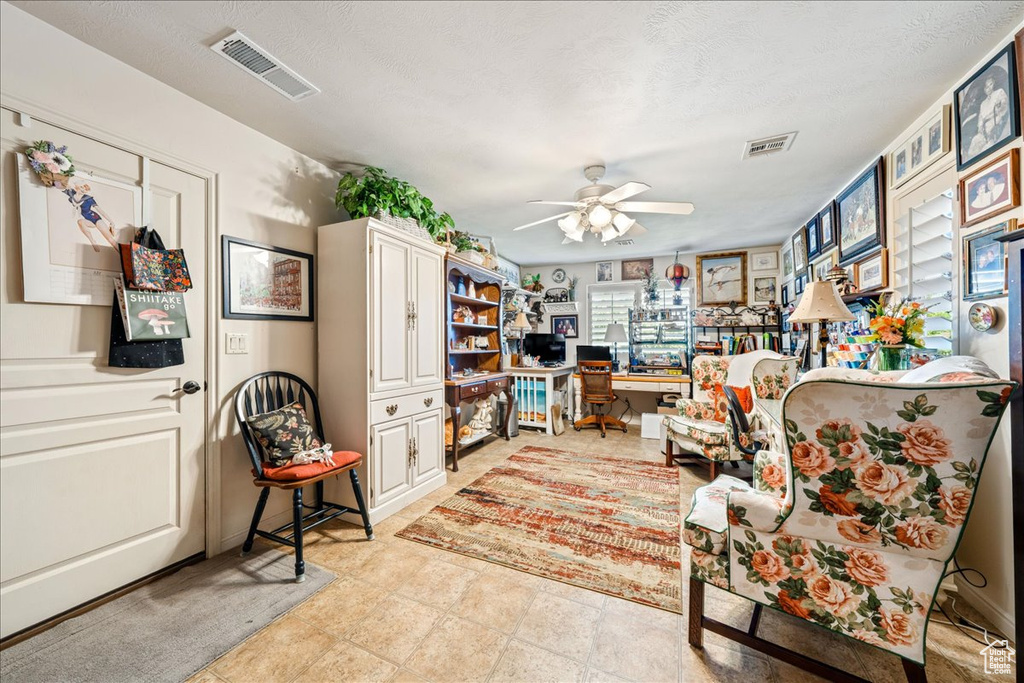 Office space with a ceiling fan and built in desk