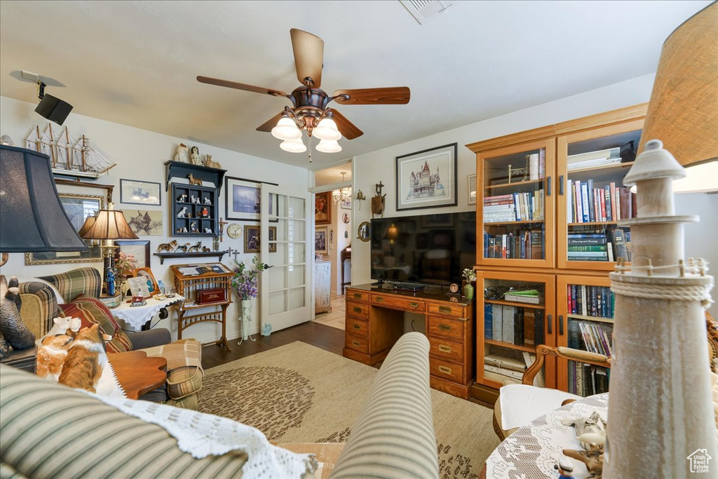 Living room with a ceiling fan and french doors