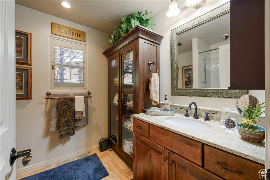 Full bathroom featuring vanity and a shower