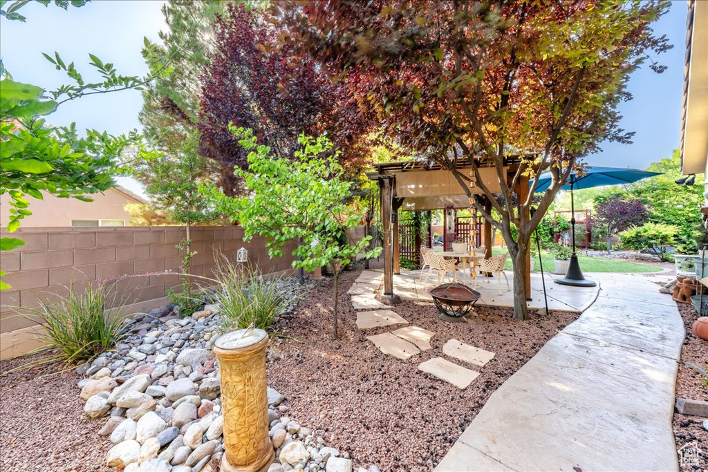 View of yard featuring an outdoor fire pit and a patio area