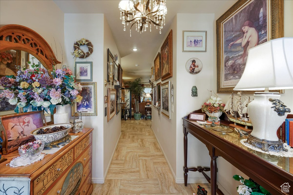 Hall with a chandelier, baseboards, and recessed lighting