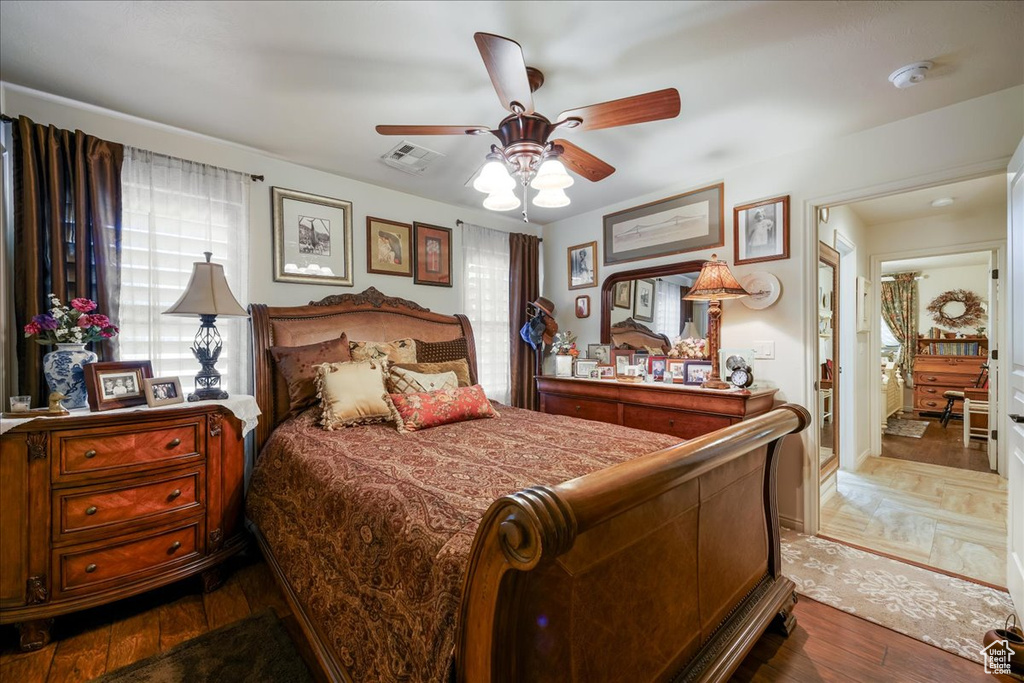 Bedroom featuring ceiling fan and dark wood-type flooring
