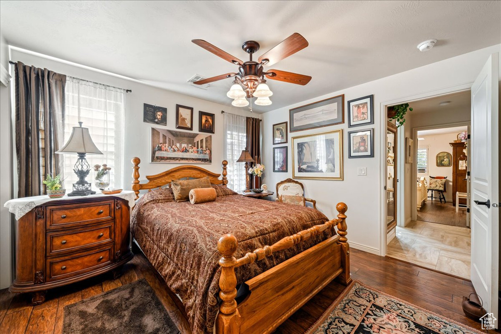 Bedroom with dark wood finished floors and a ceiling fan