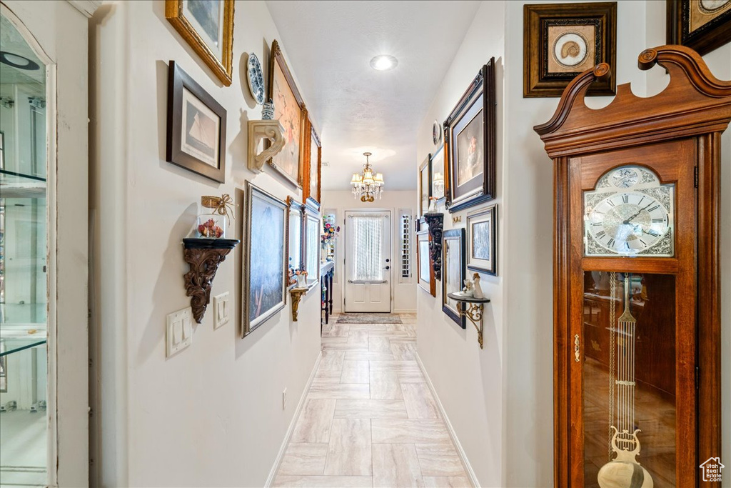 Hallway featuring a chandelier and recessed lighting