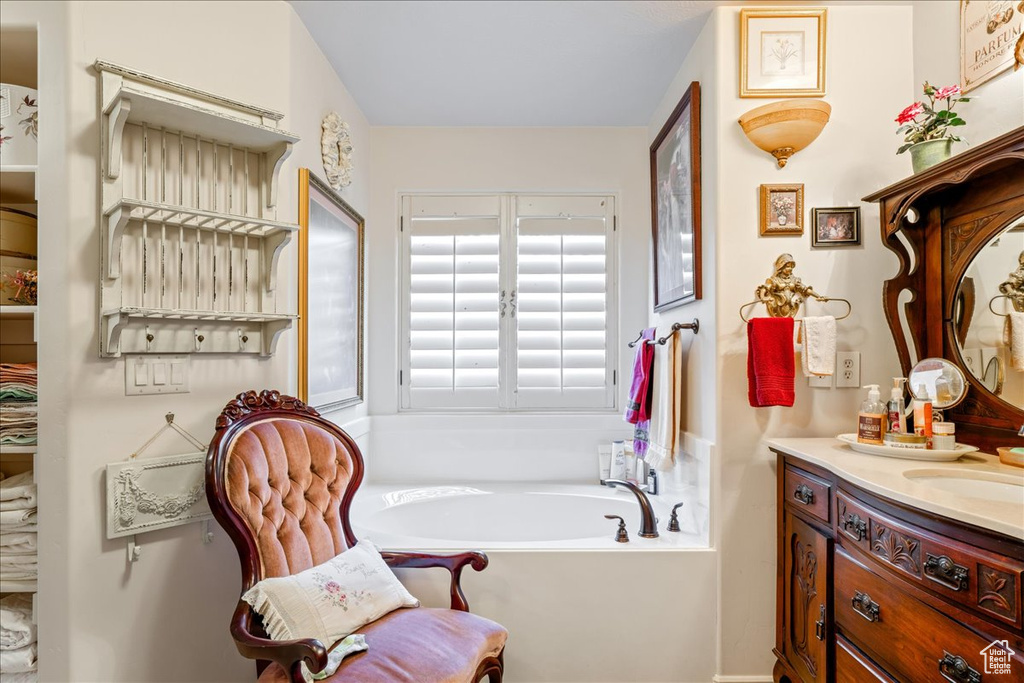 Full bathroom with vanity and a garden tub