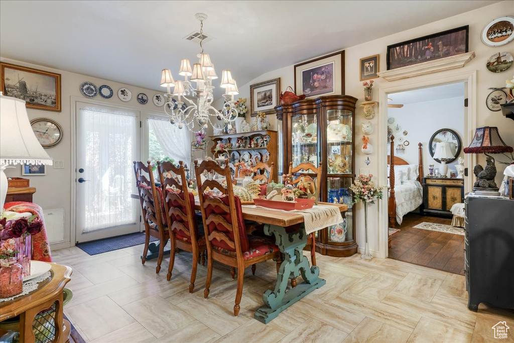 Dining room featuring a chandelier and vaulted ceiling
