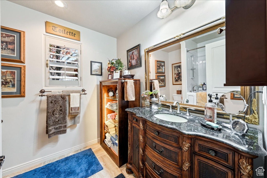 Bathroom with vanity and wood finished floors