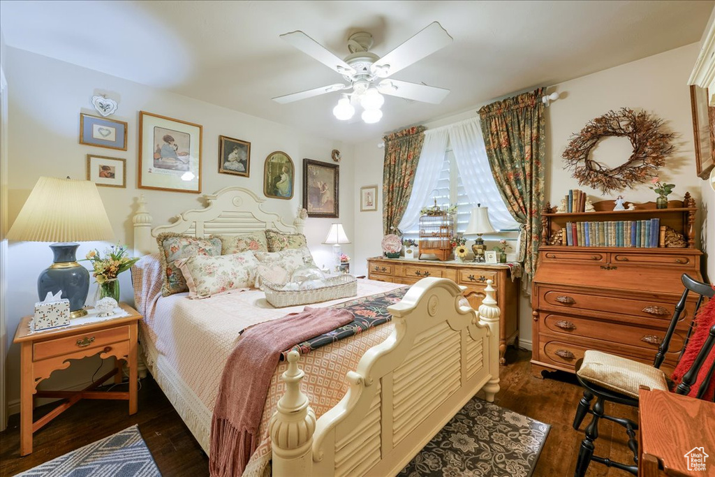 Bedroom with dark wood-type flooring and ceiling fan