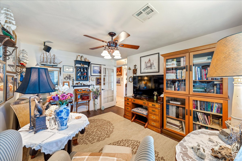 Living room featuring french doors and a ceiling fan