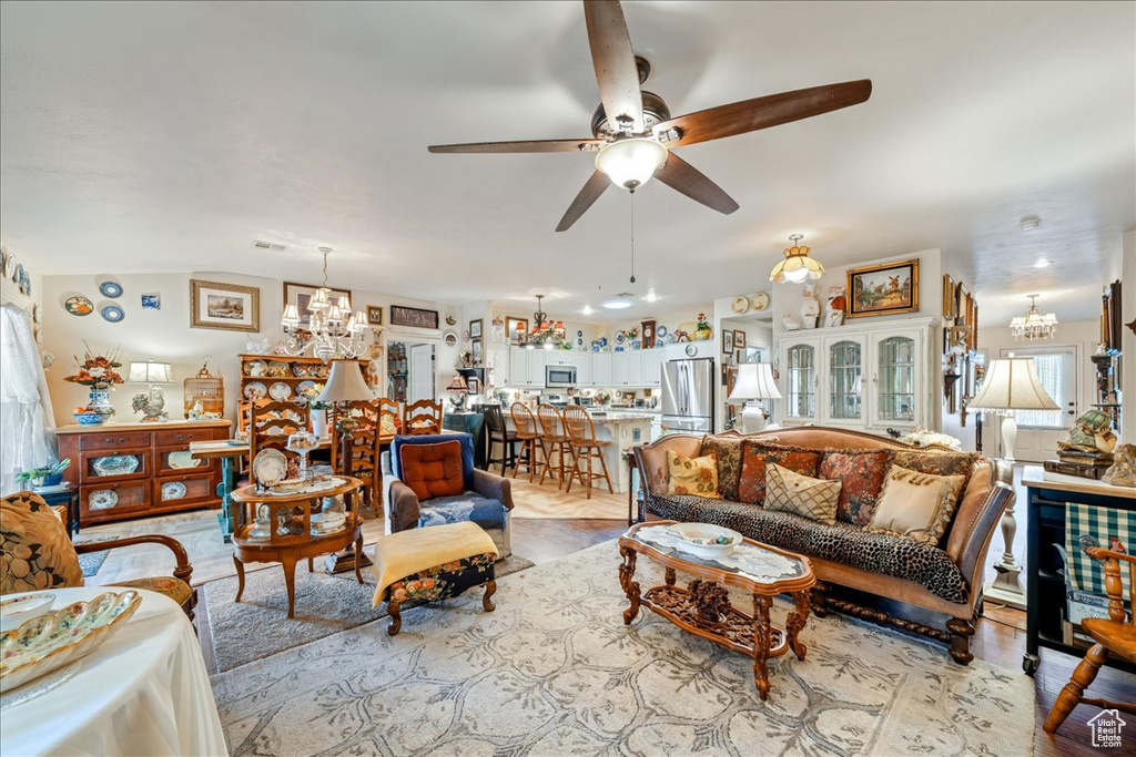Living area featuring a chandelier and ceiling fan