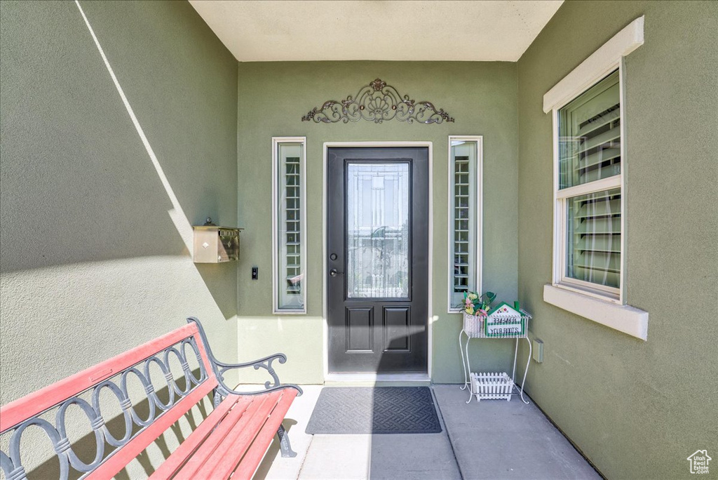 Entrance to property with stucco siding