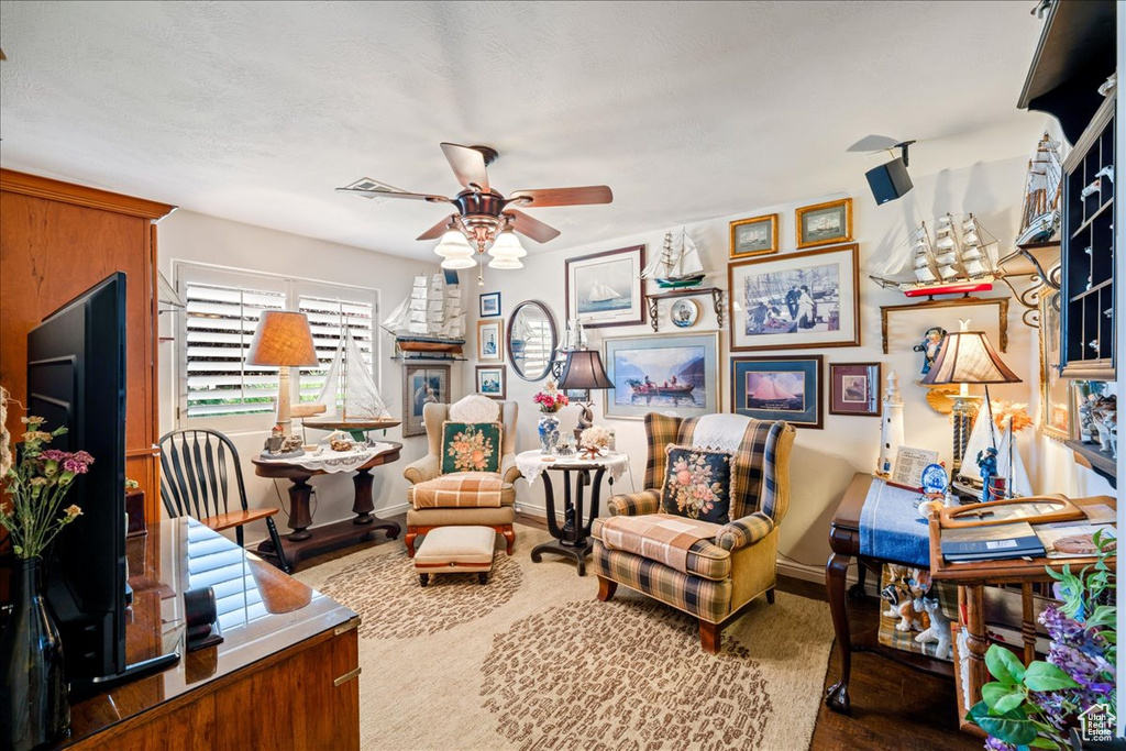 Living room with ceiling fan and wood finished floors