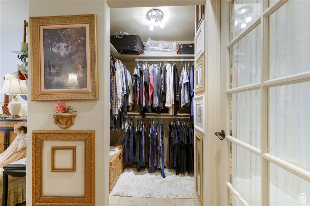 Walk in closet featuring tile patterned flooring