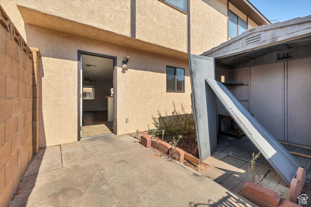 Property entrance with stucco siding and a patio area