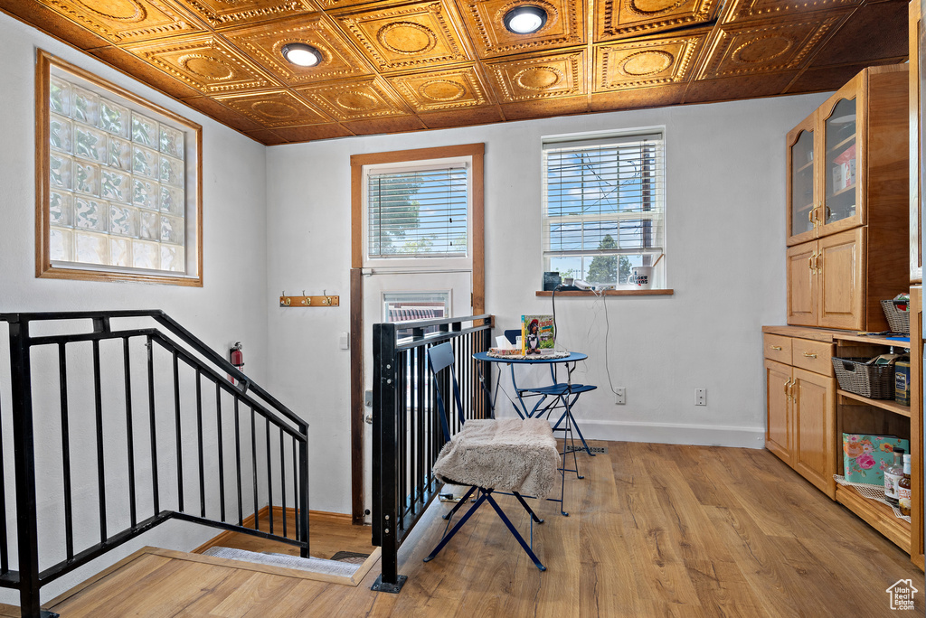 Foyer featuring baseboards, an ornate ceiling, and light wood-type flooring