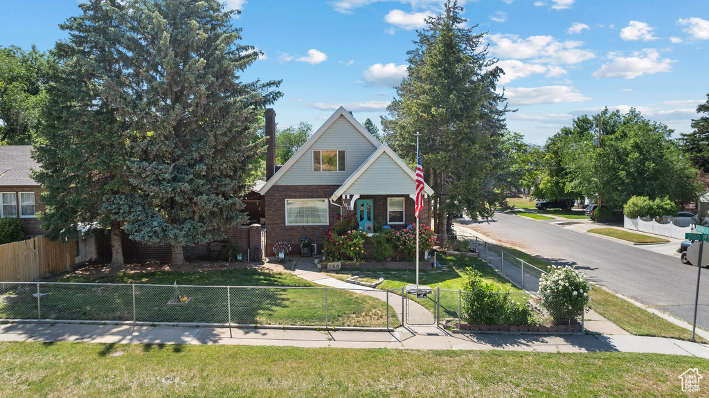 View of front of property with brick siding and a gate