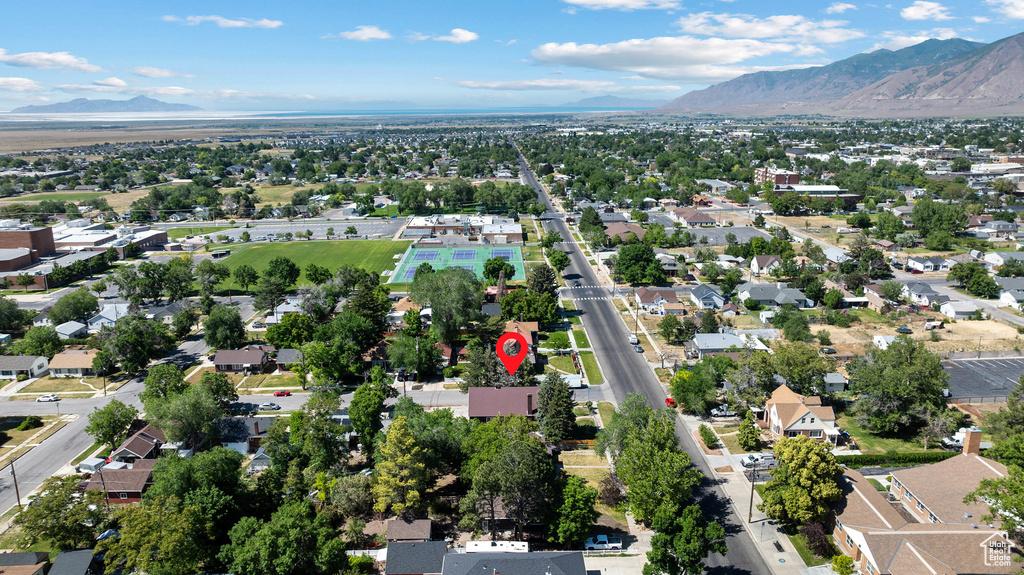 Aerial view of property's location with a mountain backdrop and nearby suburban area