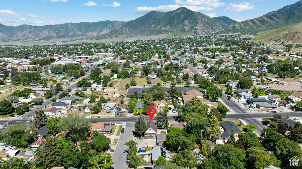 Aerial overview of property's location featuring a mountain backdrop and nearby suburban area