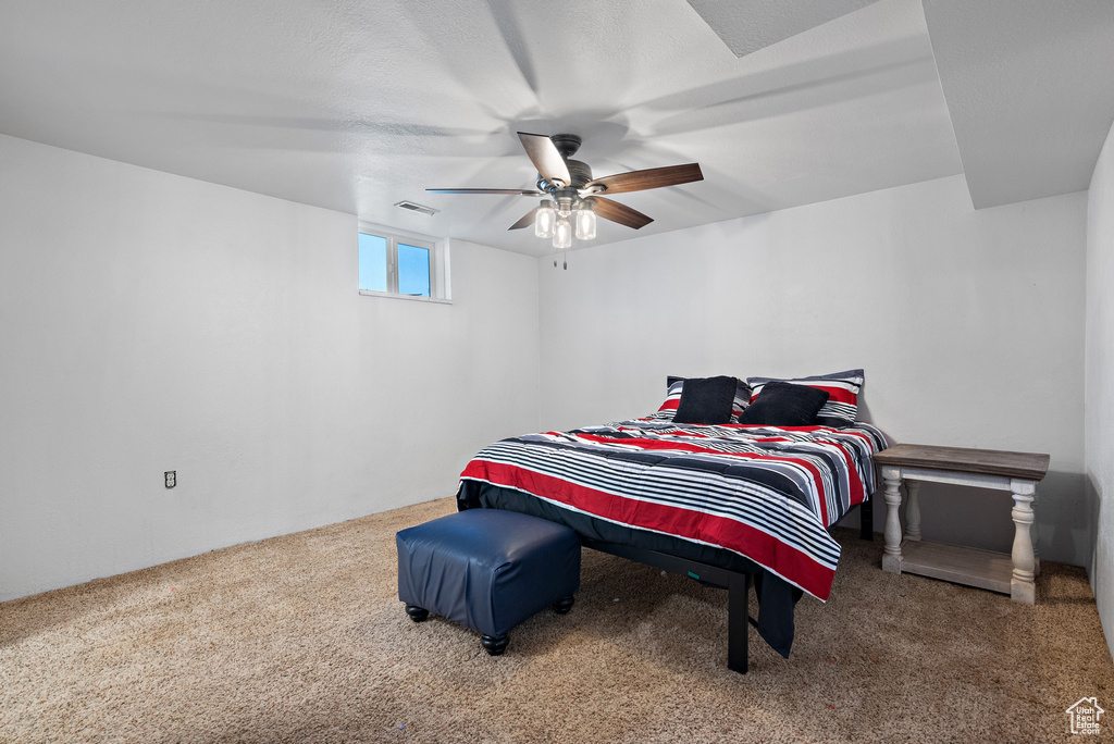 Carpeted bedroom featuring ceiling fan