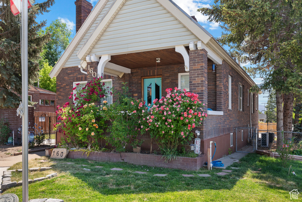 View of home's exterior featuring a chimney and brick siding