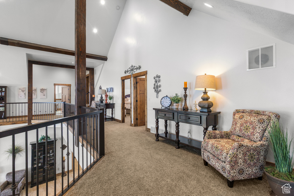 Hall with carpet flooring, high vaulted ceiling, beam ceiling, recessed lighting, and baseboards