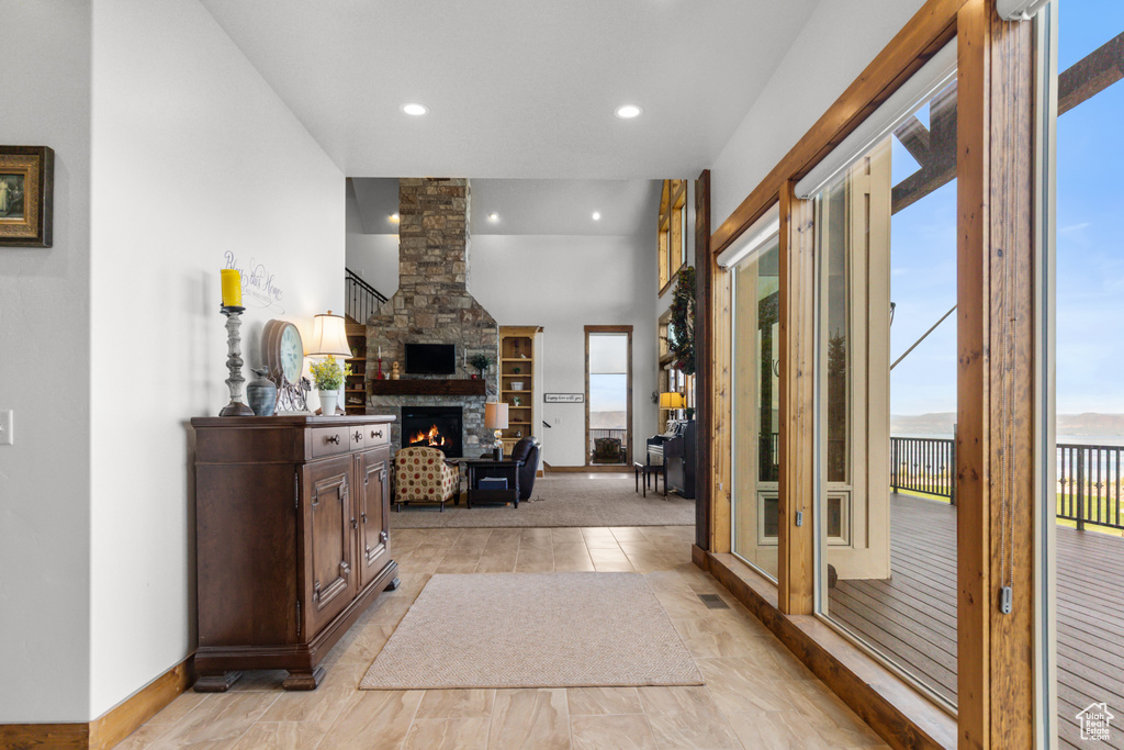 Entrance foyer featuring healthy amount of natural light, a fireplace, recessed lighting, and baseboards