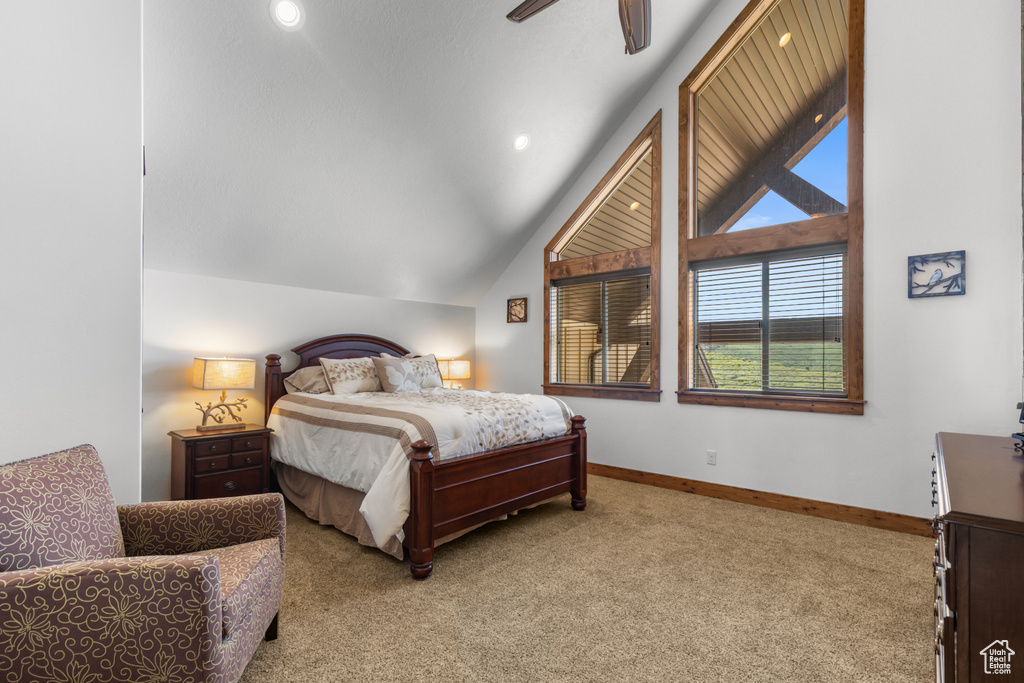 Bedroom with carpet floors, baseboards, lofted ceiling, and ceiling fan
