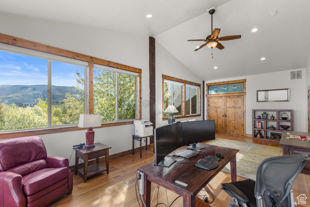 Living room featuring a desk, ceiling fan, lofted ceiling, recessed lighting, and a mountain view