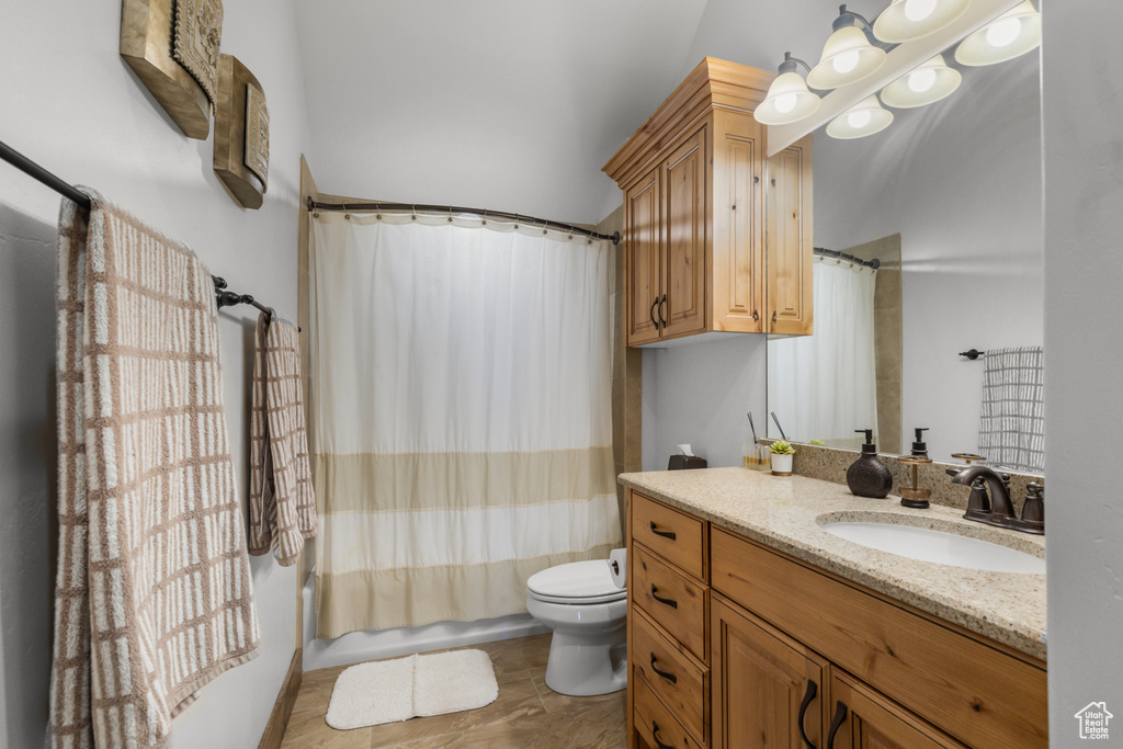 Full bath with vanity, toilet, and shower / bath combination with curtain