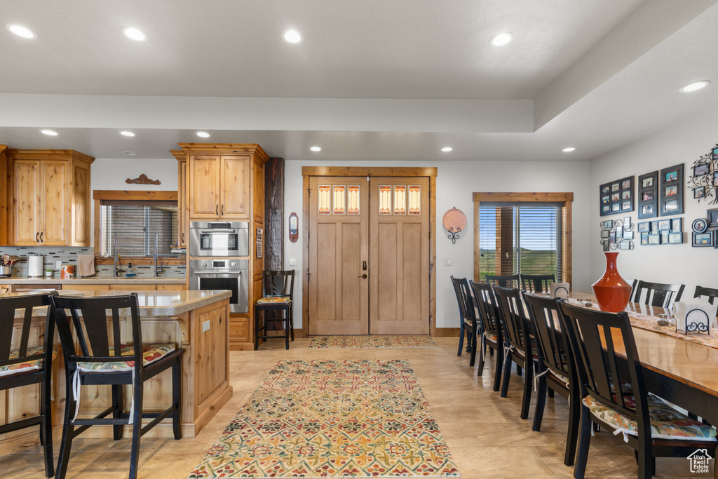 Kitchen featuring recessed lighting, a kitchen bar, and double oven