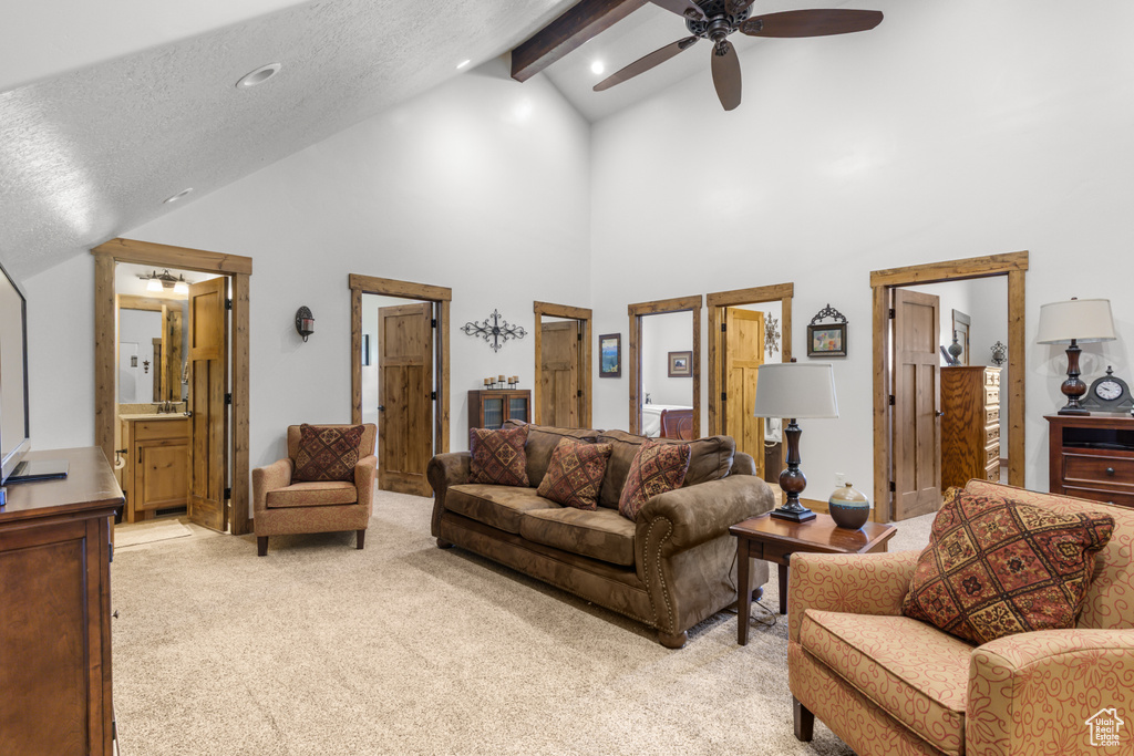 Living room with ceiling fan, light carpet, high vaulted ceiling, beam ceiling, and recessed lighting