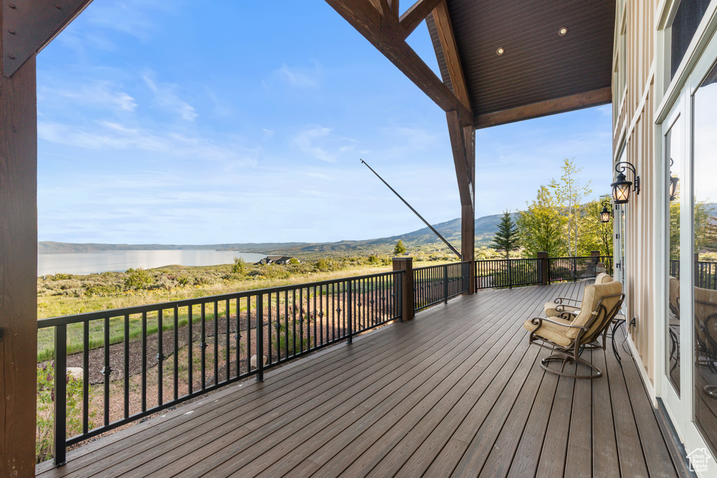 Deck featuring a water and mountain view