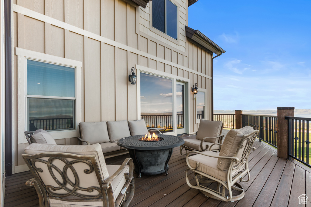 Deck with an outdoor living space with a fire pit
