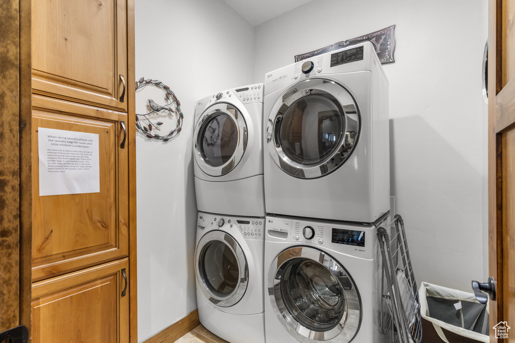 Laundry room with stacked washer / dryer and cabinet space
