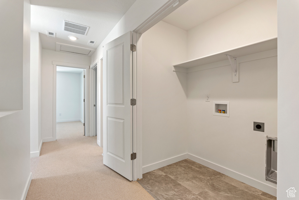 Washroom featuring hookup for an electric dryer, washer hookup, attic access, and baseboards