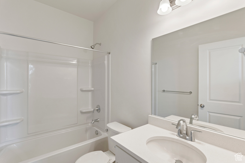 Full bath with vanity, toilet, and shower / washtub combination