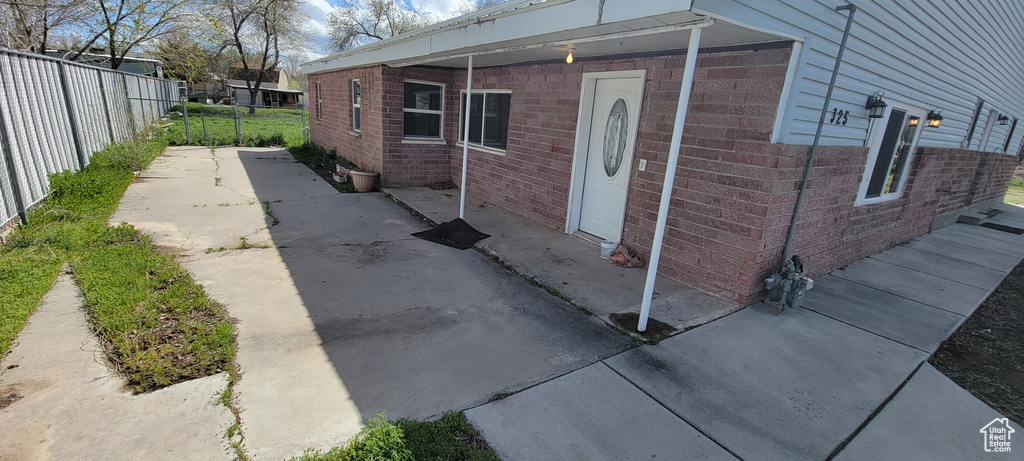 View of property exterior with brick siding