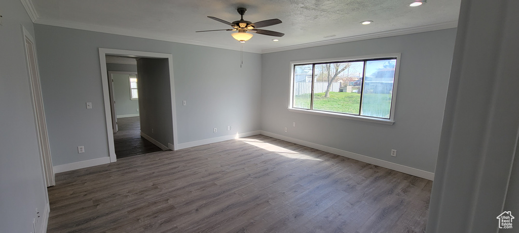Unfurnished room featuring ornamental molding, wood finished floors, a ceiling fan, recessed lighting, and baseboards