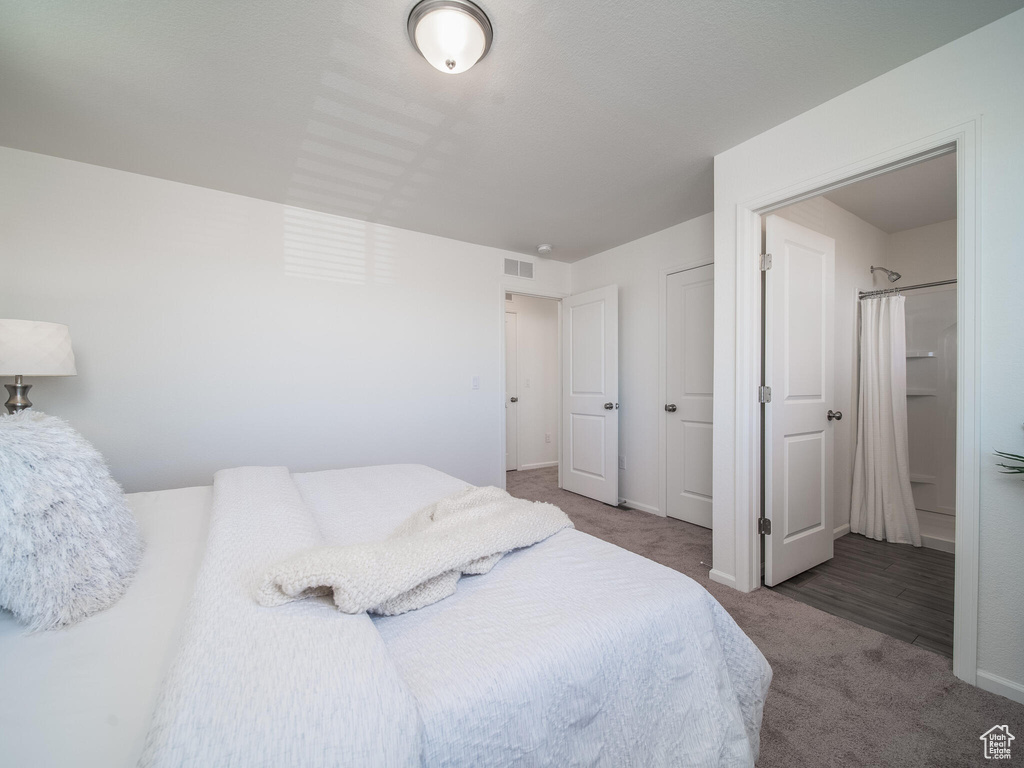 Bedroom featuring carpet and baseboards