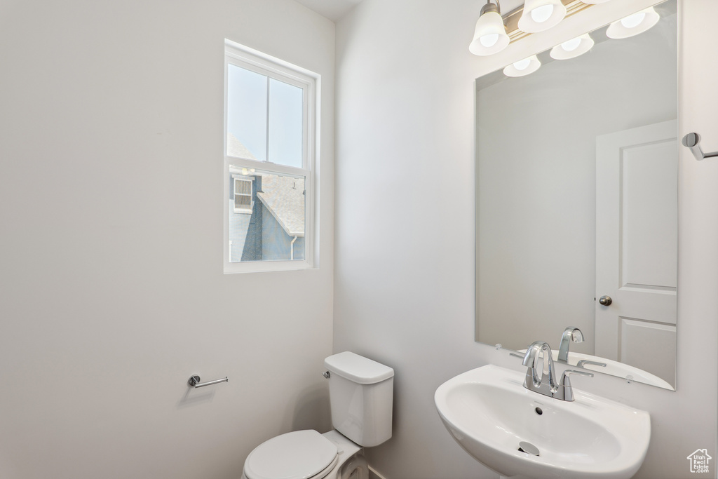 Half bathroom featuring toilet and a sink