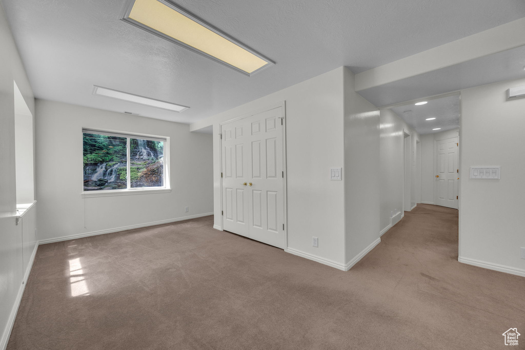 Unfurnished bedroom with carpet floors, baseboards, and a closet