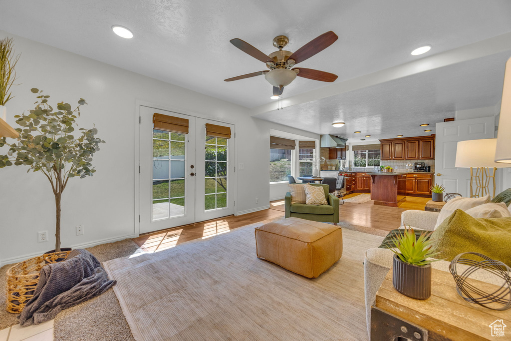 Living area featuring french doors, baseboards, a ceiling fan, and recessed lighting