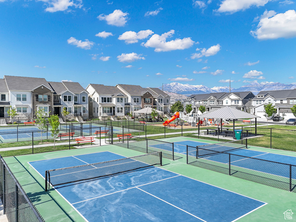 View of tennis court with a residential view, a gazebo, and a mountain view