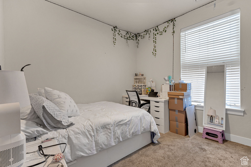 Bedroom featuring carpet flooring and baseboards