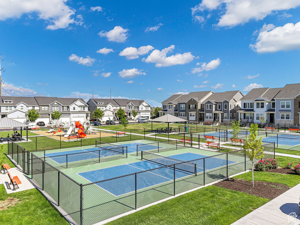 View of tennis court featuring a residential view