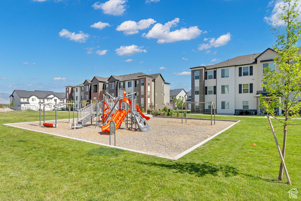 Community playground featuring a residential view and a yard