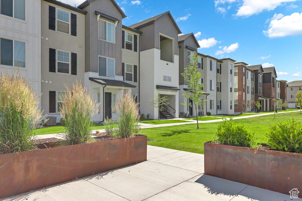 View of community featuring a residential view and a lawn